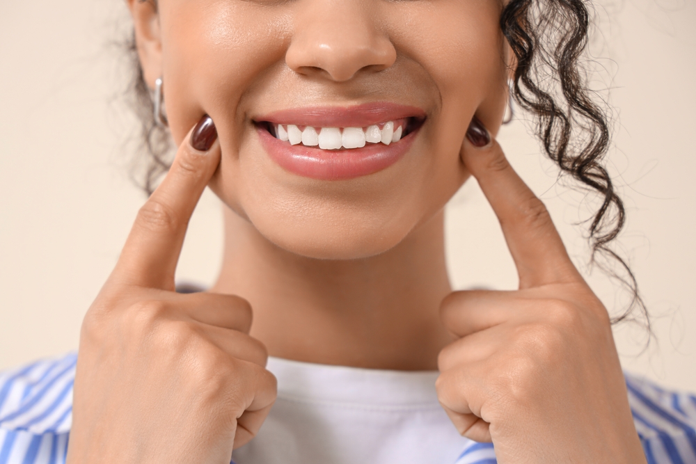 Patient consulting with dentist about teeth whitening in modern office