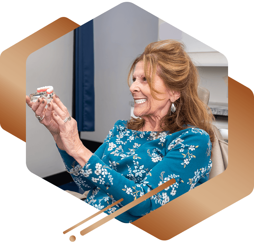 lady holding a full arch dental implant