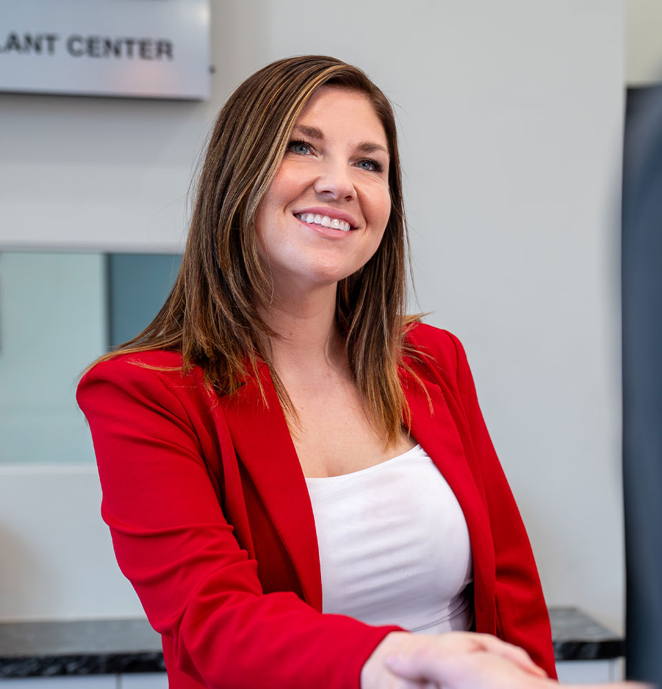 lady in red blazer at front desk
