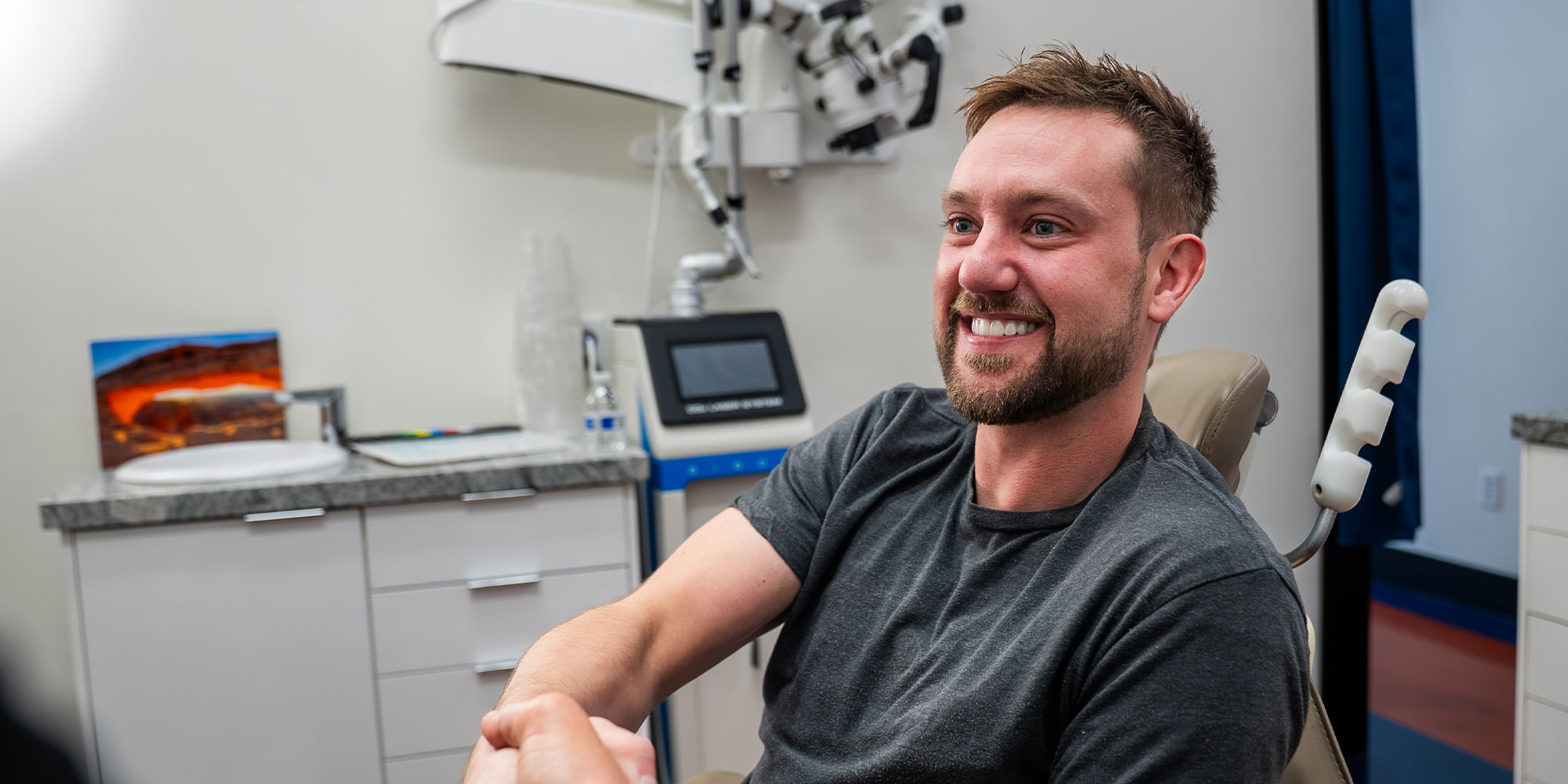 man in grey shirt shaking hands with doctor