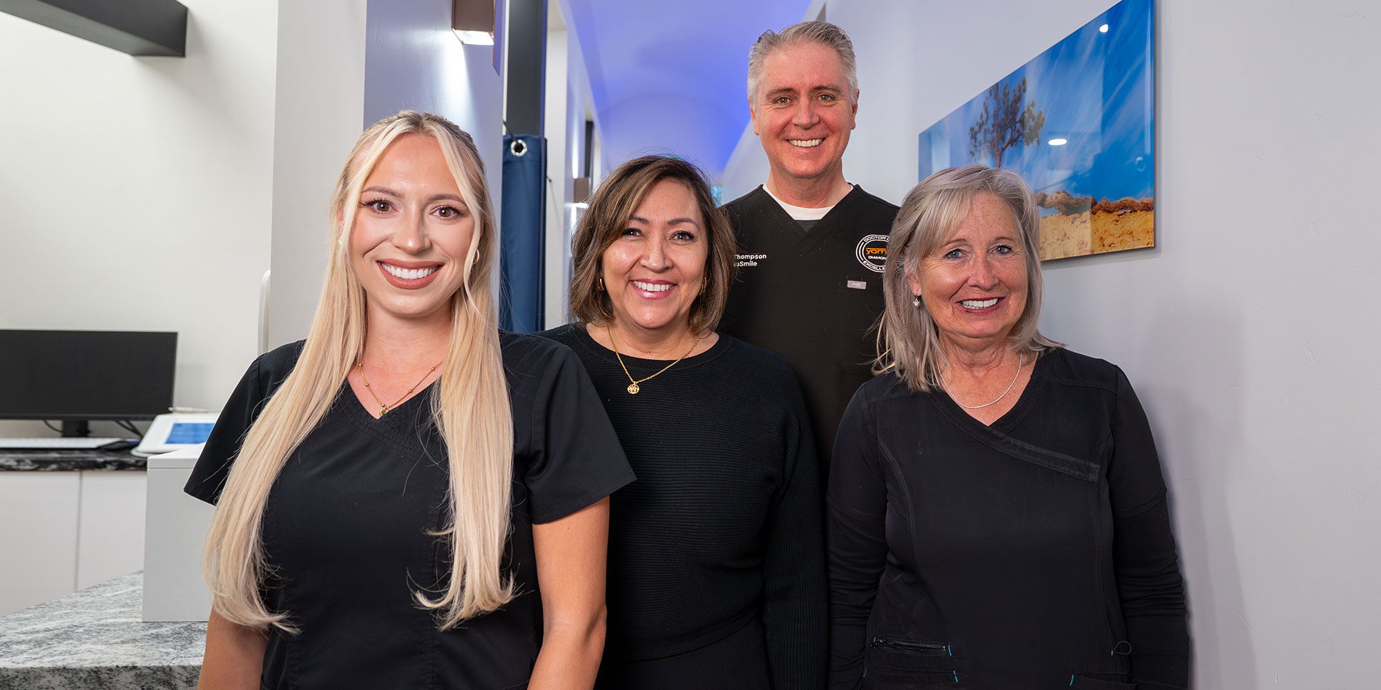 team smiling standing in hallway